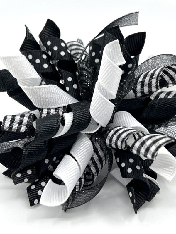 A black and white bow with polka dots