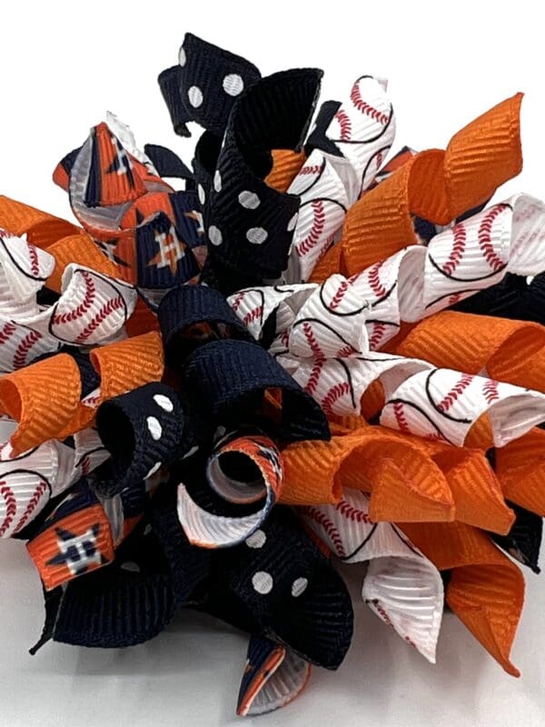 A baseball wreath with orange and black ribbons.