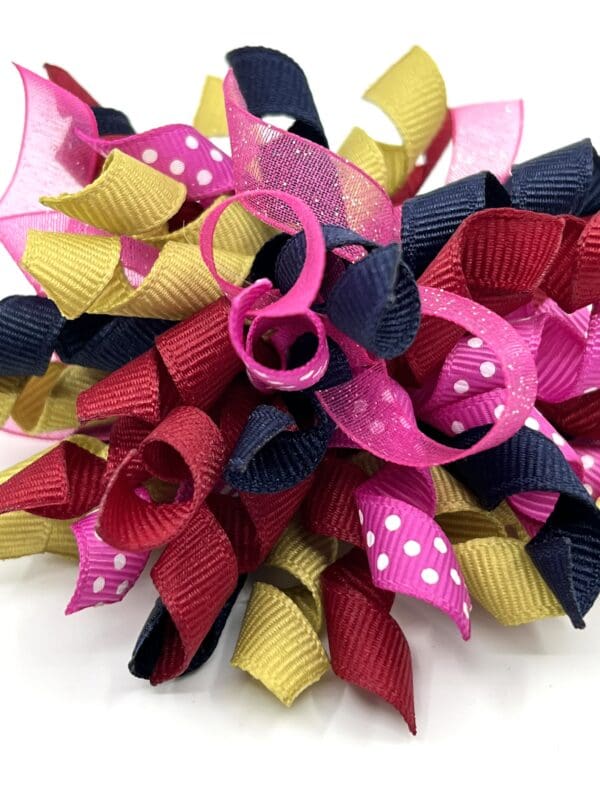 A close up of a colorful bow on someones head