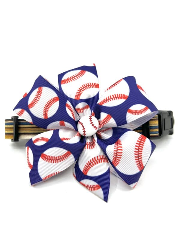 A blue and white bow with baseball balls on it