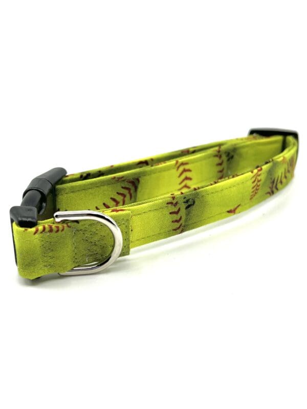 A green baseball collar with red stitching on it.