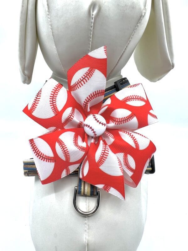 A red and white bow with baseball laces on it.