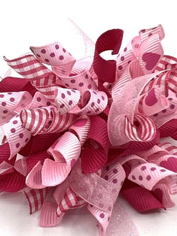 A close up of the ribbon on a pink flower