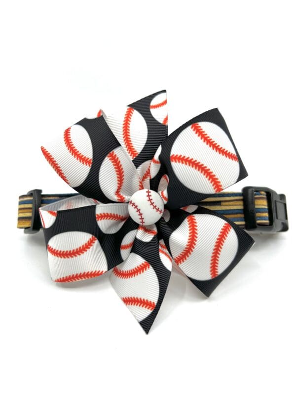A black and white hair clip with baseball fabric.