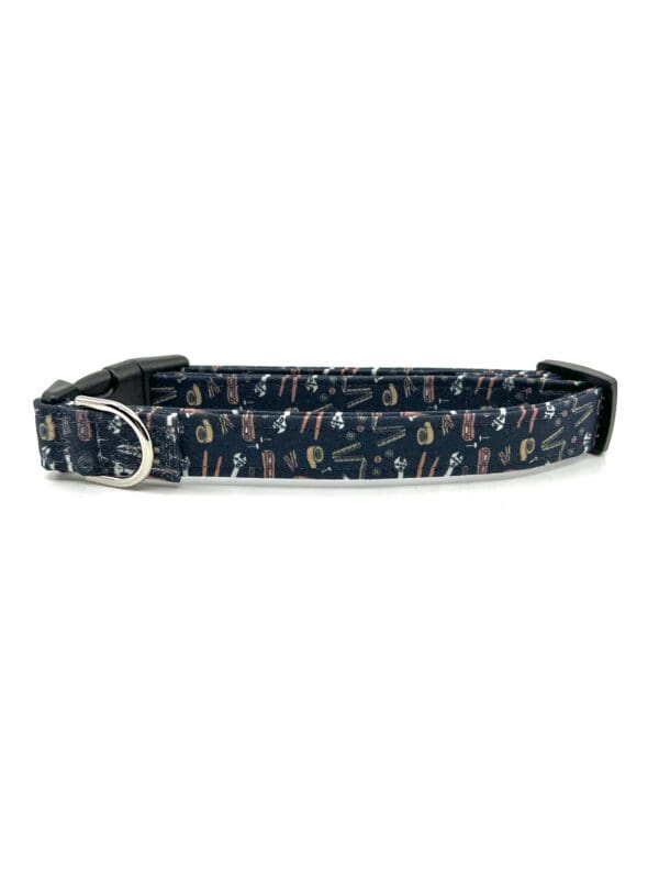 A dog collar with a picture of cats on it.