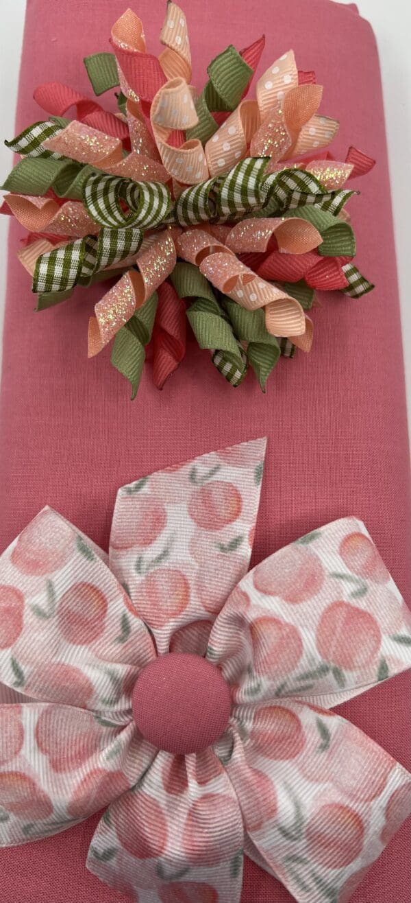 A pink table cloth with two napkins and a bow