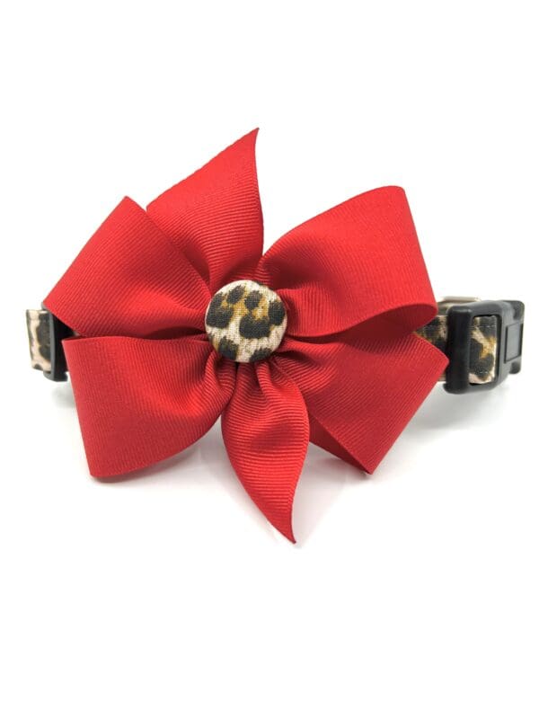A red bow with leopard print on it.