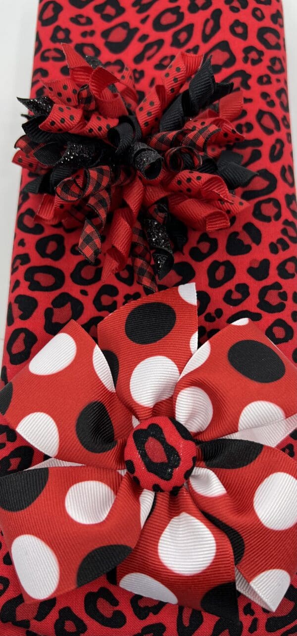 A red and black polka dot bow tie with leopard print.