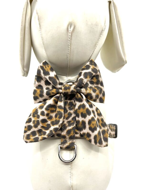 A dog 's collar and bow tie with leopard print.