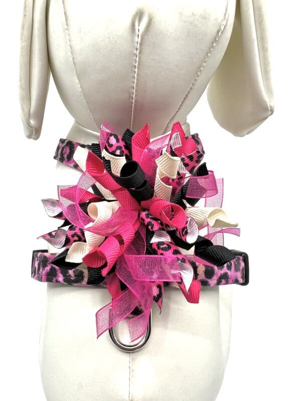 A mannequin with pink and black bows on it.
