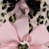 A pink and black leopard print cover with a bow.