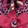 A pink and black leopard print headband with a bow.