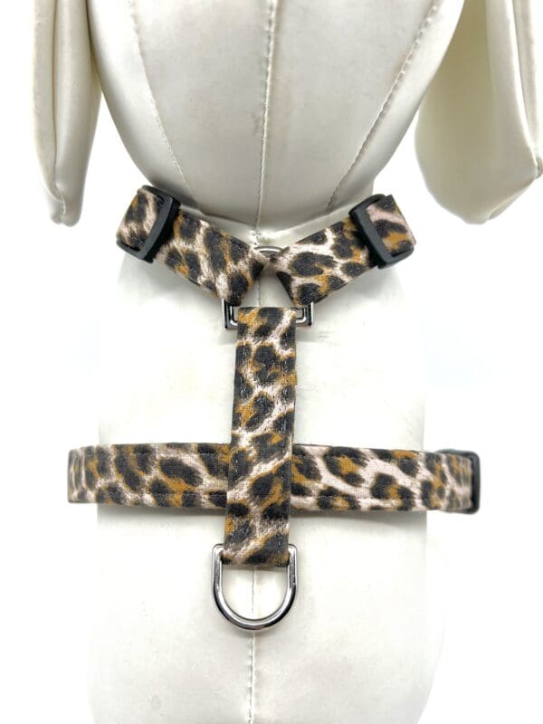 A leopard print harness with a leash attached.