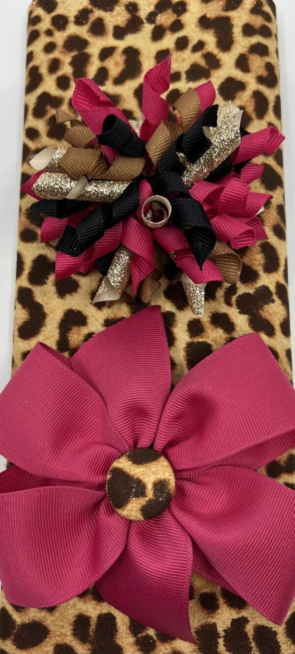 A close up of two bows on top of a leopard print box