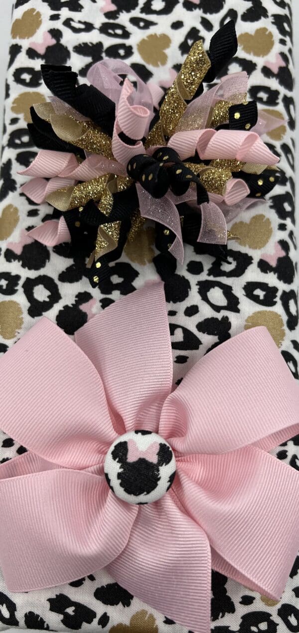 A close up of the bow on a leopard print blanket