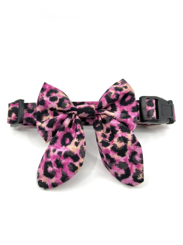 A pink leopard print bow tie collar for dogs.