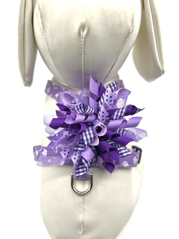 A mannequin with a purple bow on it.