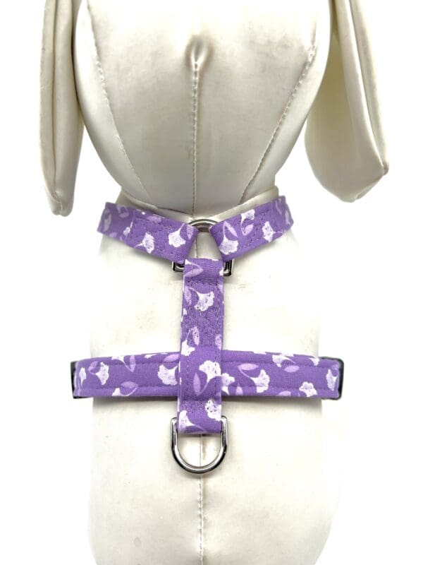 A purple harness with white hearts on it.