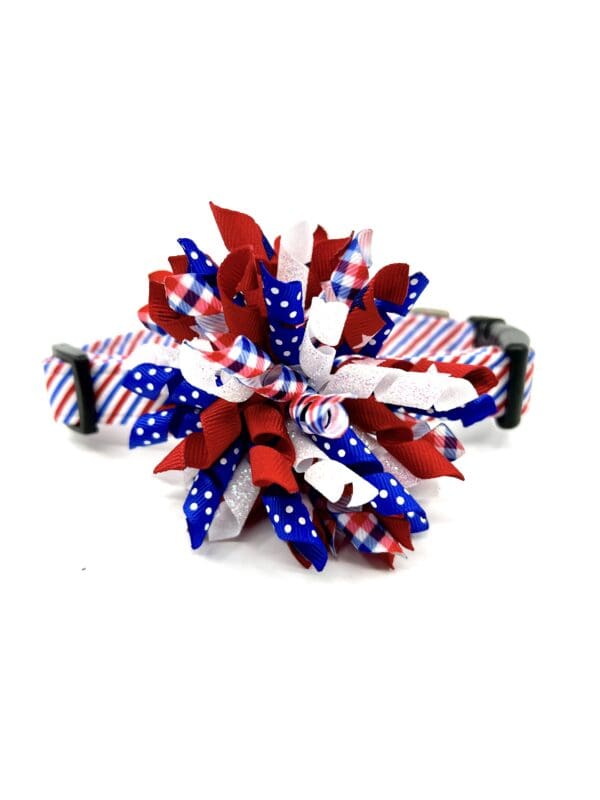 A red, white and blue bow on a dog collar.