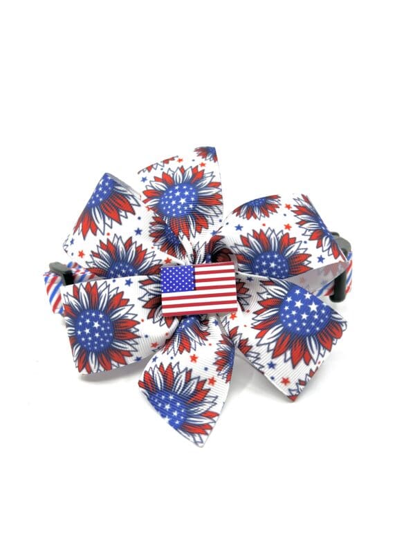 A red white and blue bow with an american flag on it.