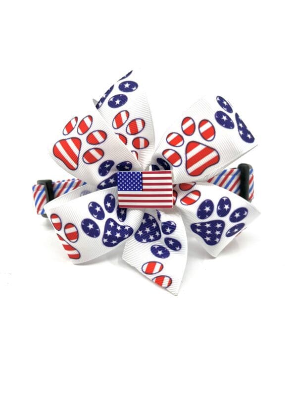 A bow tie with the american flag and paw prints.