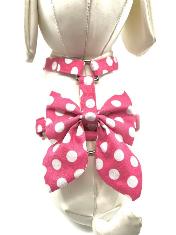 A pink and white polka dot bow tie on a dress