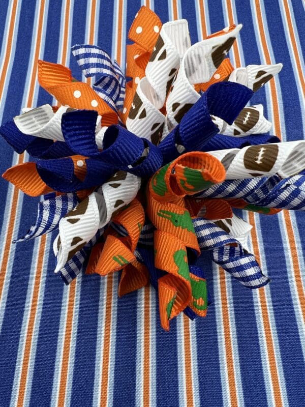 A blue and orange bow on top of a table.