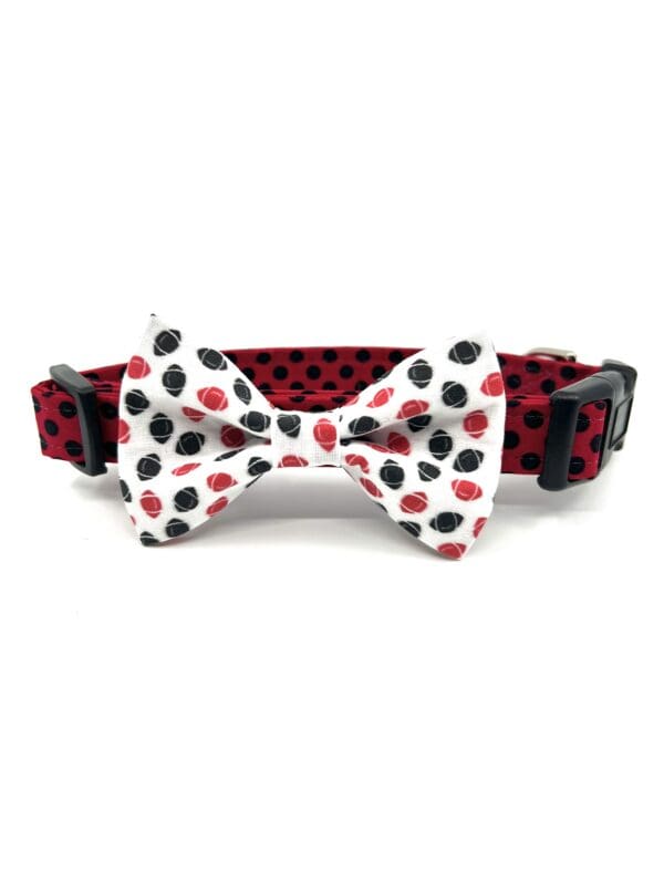 A red and black polka dot dog collar with a bow tie.