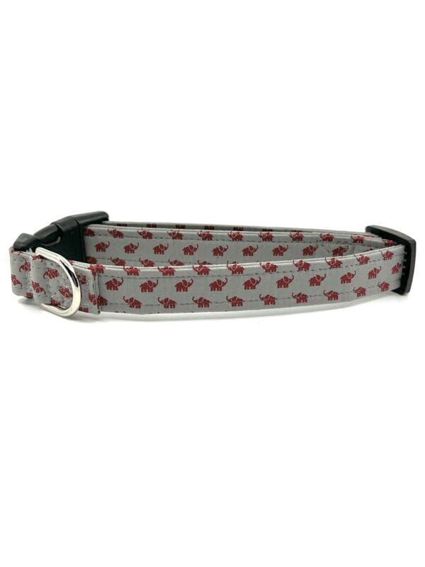 A gray dog collar with red polka dots.
