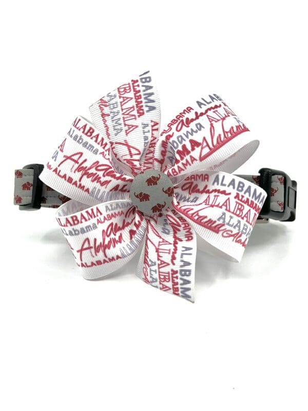 A dog collar with a flower made out of ribbon.