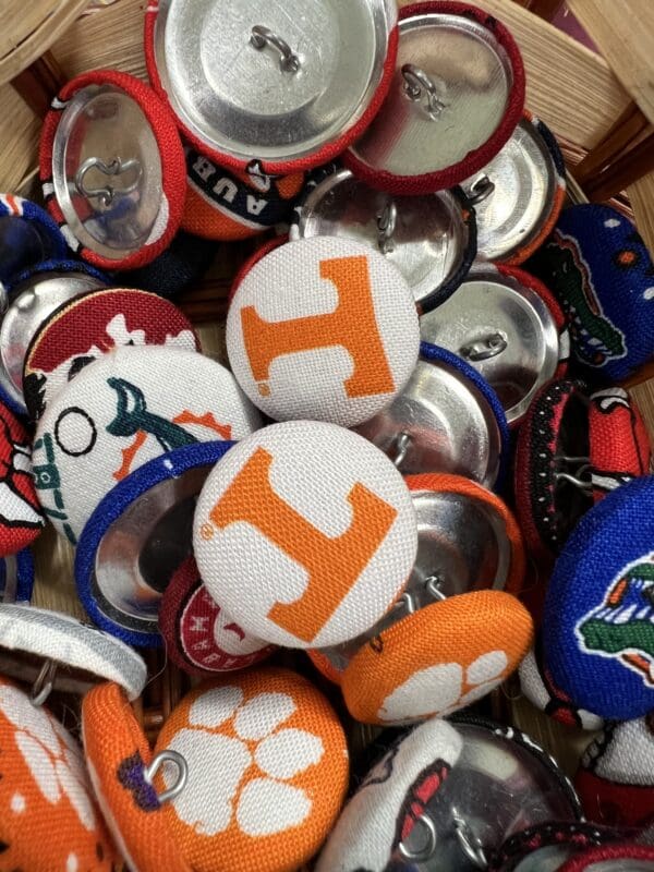 A pile of buttons with the university of tennessee logo on them.