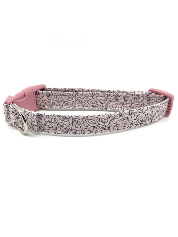 A pink and gray dog collar with a white background.