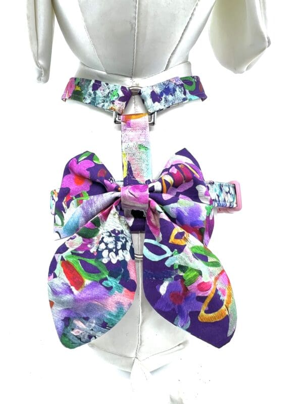 A purple bow tie with colorful designs on it.