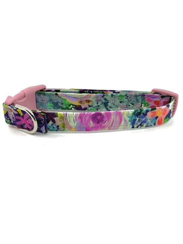 A colorful floral dog collar with pink lining.