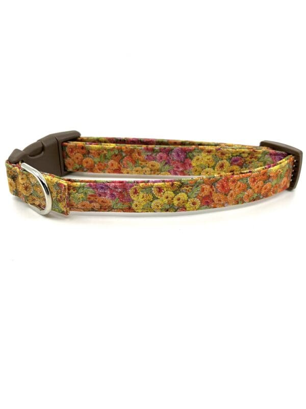 A colorful floral dog collar with metal buckle.