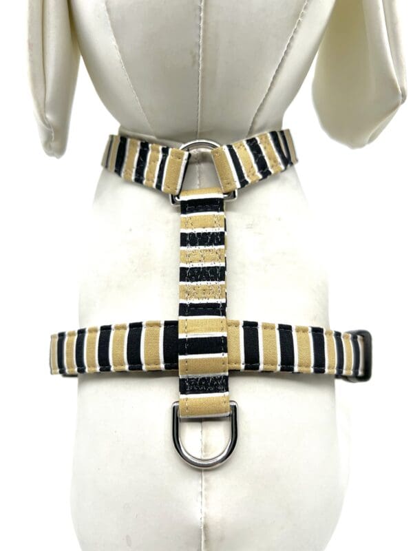 A dog harness with a black and tan stripe pattern.