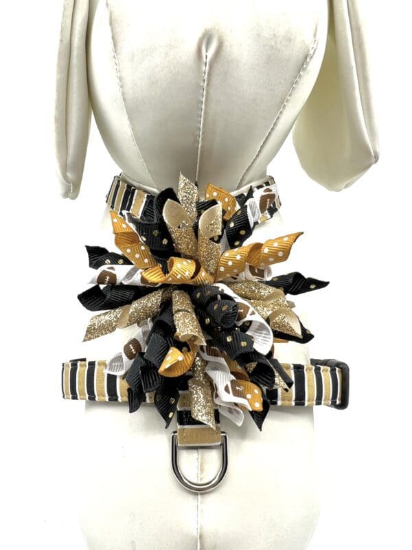A white dress with a black and gold bow on it