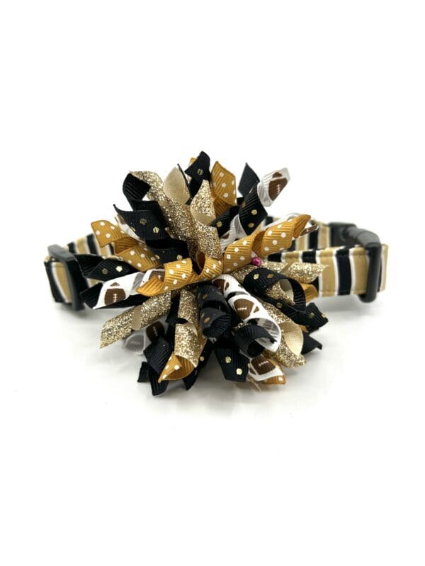 A black and gold bracelet with a flower