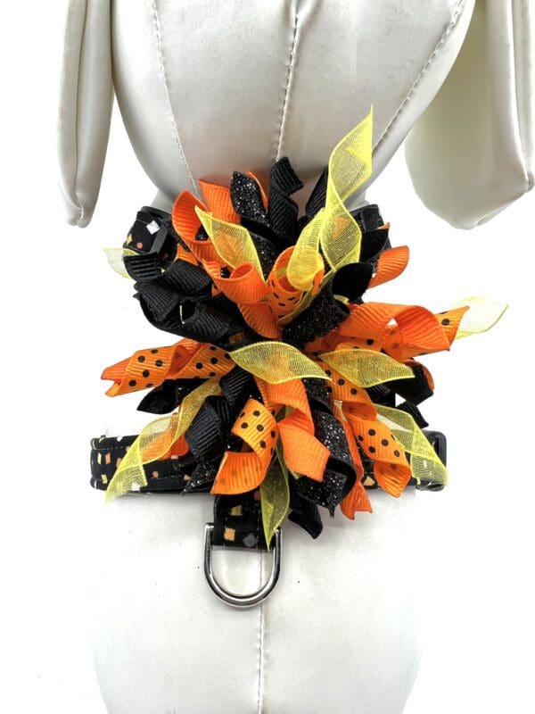 A black and orange bow with polka dots on it.