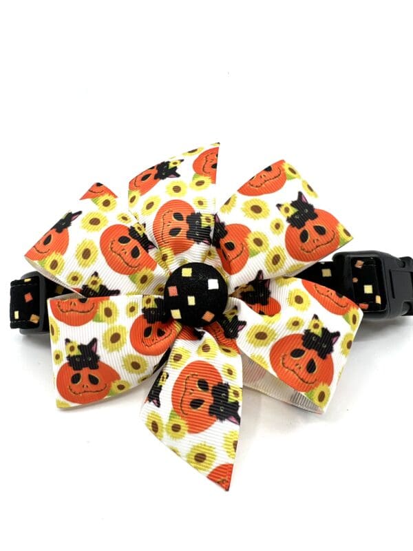 A bow that is made of fabric with pumpkins.