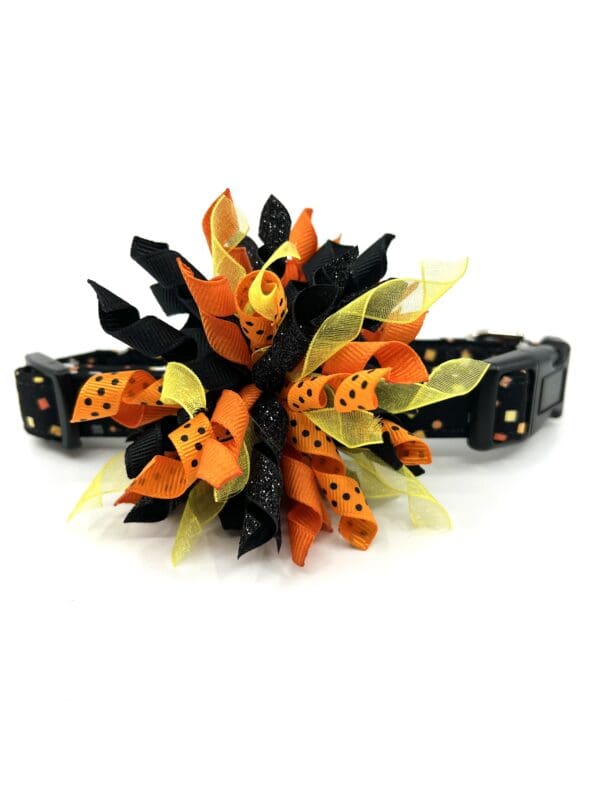 A dog collar with a flower on it.