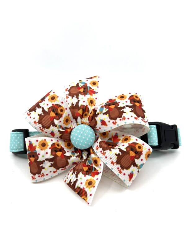 A dog collar with a bow and sunflowers on it.