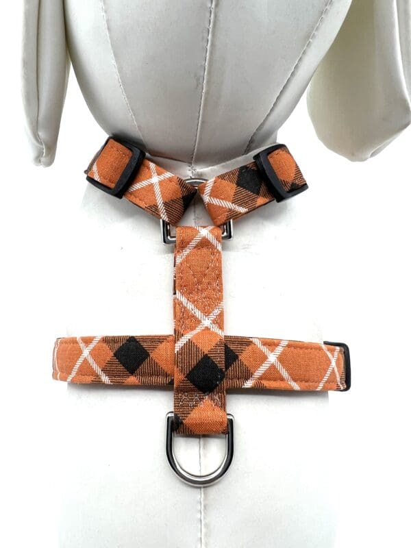 A dog 's harness with an argyle pattern.