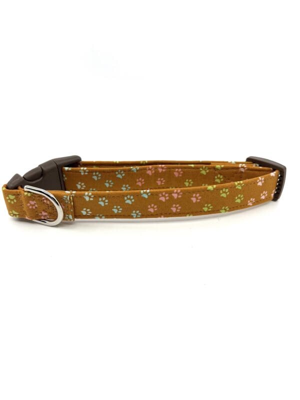 A brown dog collar with colorful flowers on it.