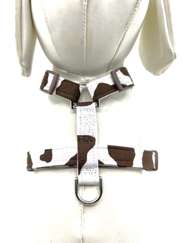 A harness with brown and white spots on it.