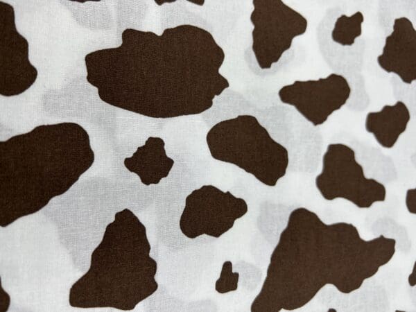 A close up of the cow pattern on a sheet