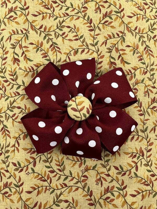 A red and white flower with leaves on it.