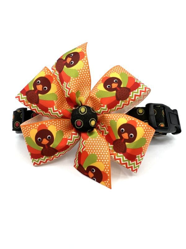 A dog collar with a turkey bow tie on it.