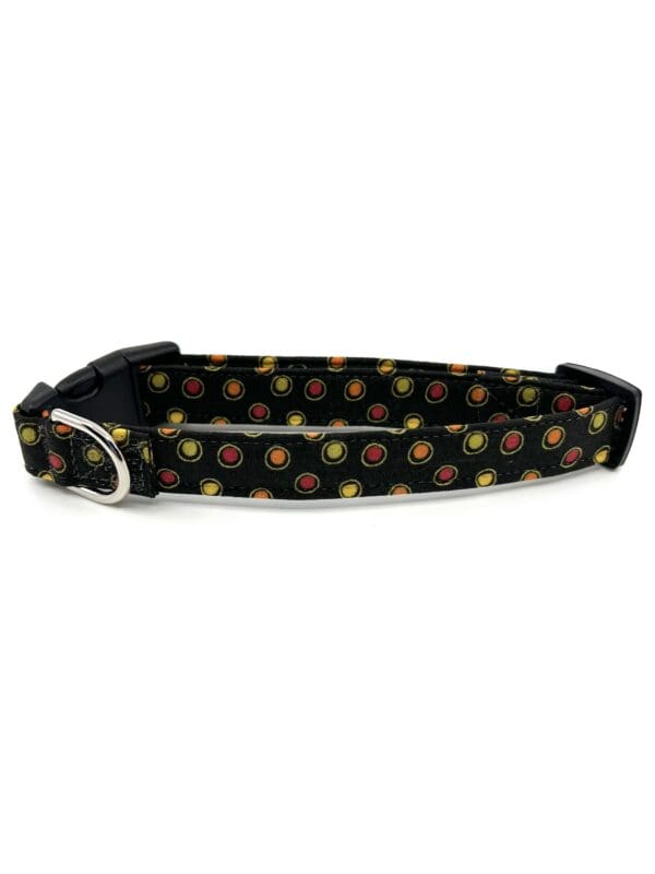 A black dog collar with yellow and red flowers.