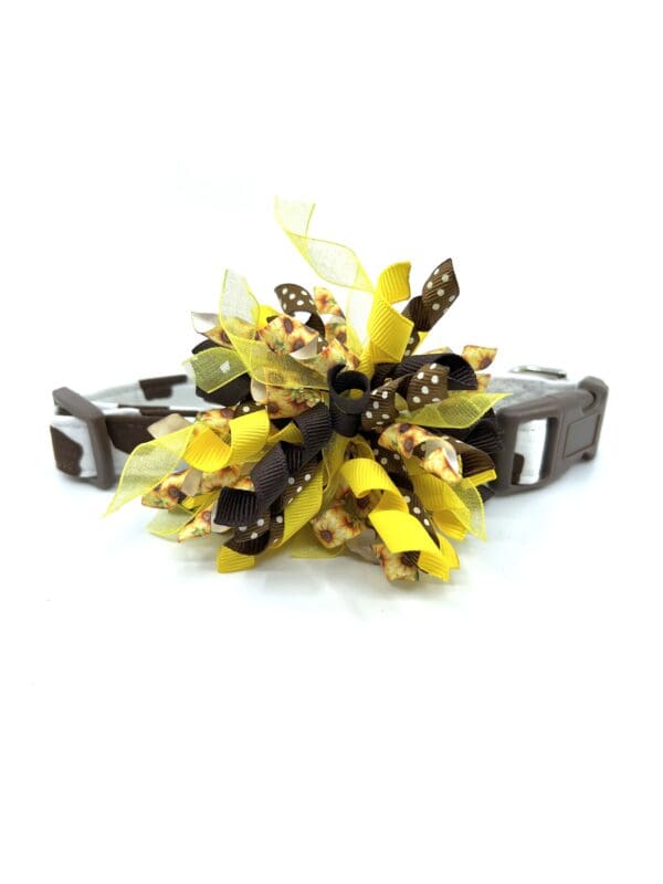 A yellow and brown flower with black ribbon.
